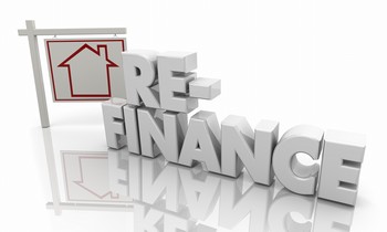Blocks spelling "refinance" with a sign in the background, symbolizing the process of home refinancing