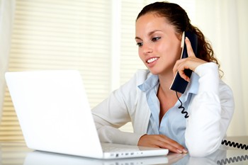 Young woman reading about USDA loans on her laptop